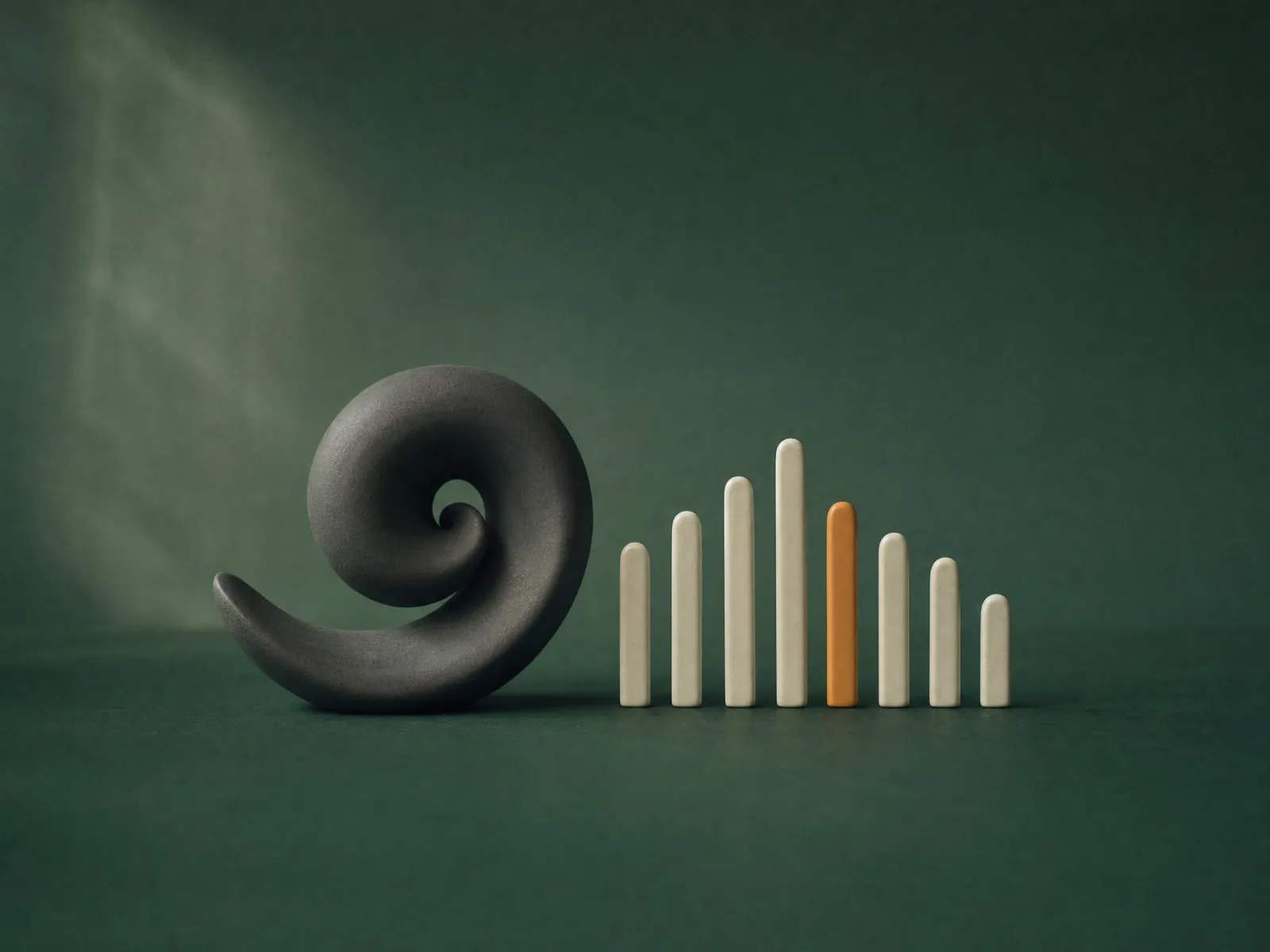 A matte charcoal ceramic shell curled into a spiral beside a row of slim off-white ceramic bars rising and falling like a sound wave, one bar amber, on a deep green backdrop.